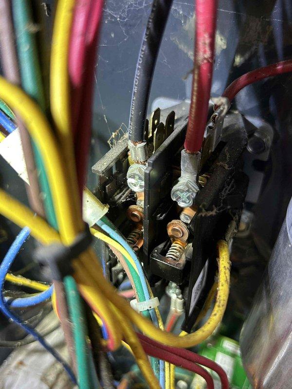Responded to a no-heat call for an 8-year-old electric HVAC system. Upon inspection of the attic-located indoor unit, discovered loose electrical connections at the terminal block. Cleaned accumulated dust and cobwebs from terminal connections, then re-secured all wiring with proper torque on terminal screws. System tested successfully after repair with proper heating function restored.