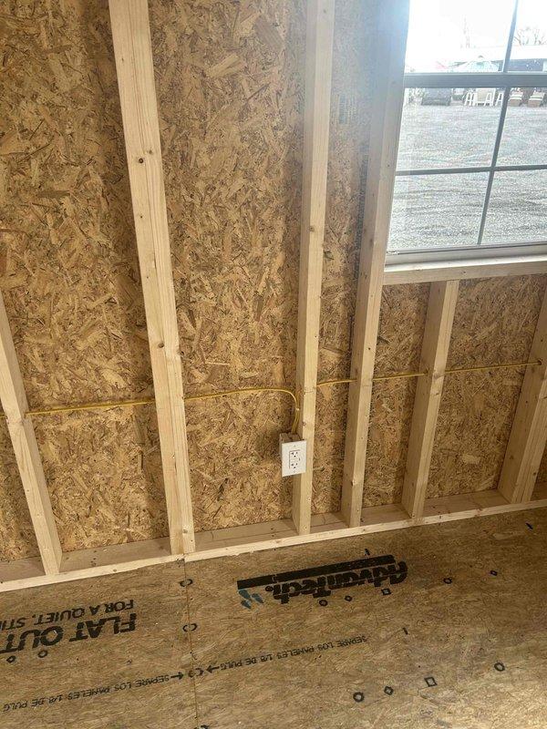 Installed a 200AMP panel (Rapp 12x281) with two breakers in new construction framing. Completed rough-in electrical work including installation of one GFCI outlet, one duplex receptacle, one single pole switch, and two keyless fixtures with bulbs. All components properly secured to OSB walls and ceiling framework per code requirements.