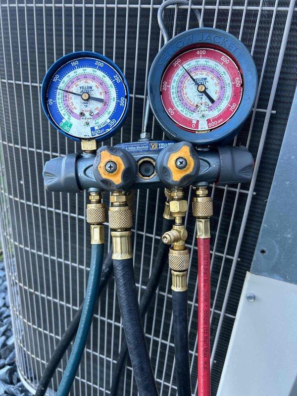 Responded to customer with heat pump not working complaint. System inspection revealed frozen outdoor unit. Connected manifold gauges to diagnose refrigerant pressures, confirming low refrigerant charge. Completed system recharge, cleared ice from coil, and verified proper operation with normal pressure readings. Unit now functioning correctly with proper heat output.