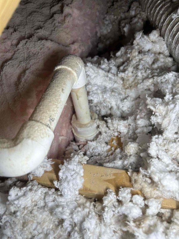 Investigated noise complaint in attic regarding dripping/knocking sounds during heating cycles. Inspected HVAC condensate drain line system and discovered loose insulation around PVC drain pipe causing vibration when unit operates. Secured drain pipe connections and properly repositioned insulation material to eliminate the noise issue. Customer confirmed resolution after system test.