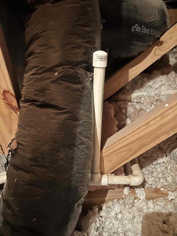 Investigated noise complaint in attic regarding dripping/knocking sounds during heating cycles. Inspected HVAC condensate drain line system and discovered loose insulation around PVC drain pipe causing vibration when unit operates. Secured drain pipe connections and properly repositioned insulation material to eliminate the noise issue. Customer confirmed resolution after system test.