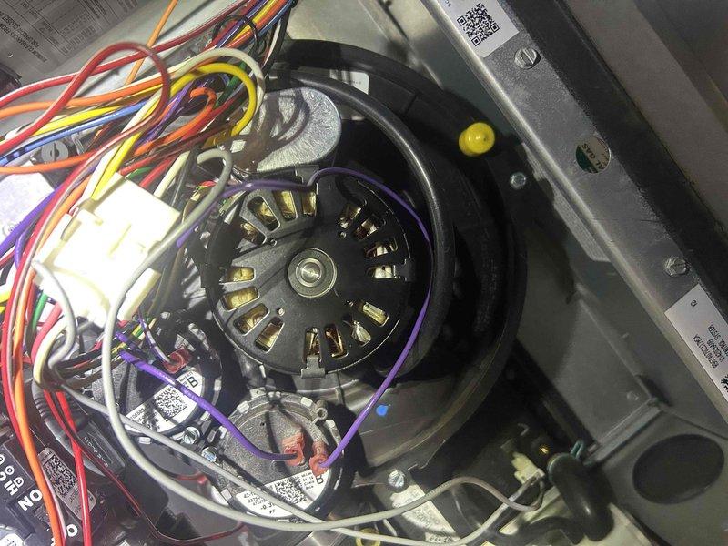 Responded to service call for system operating with loud noise, suspected to be from the inducer motor. Upon inspection, accessed and examined the blower motor assembly, which had multiple electrical connections and was properly wired. Visual inspection revealed no signs of damage or deterioration to the motor or surrounding components. System was tested and is now operating correctly without the reported noise.