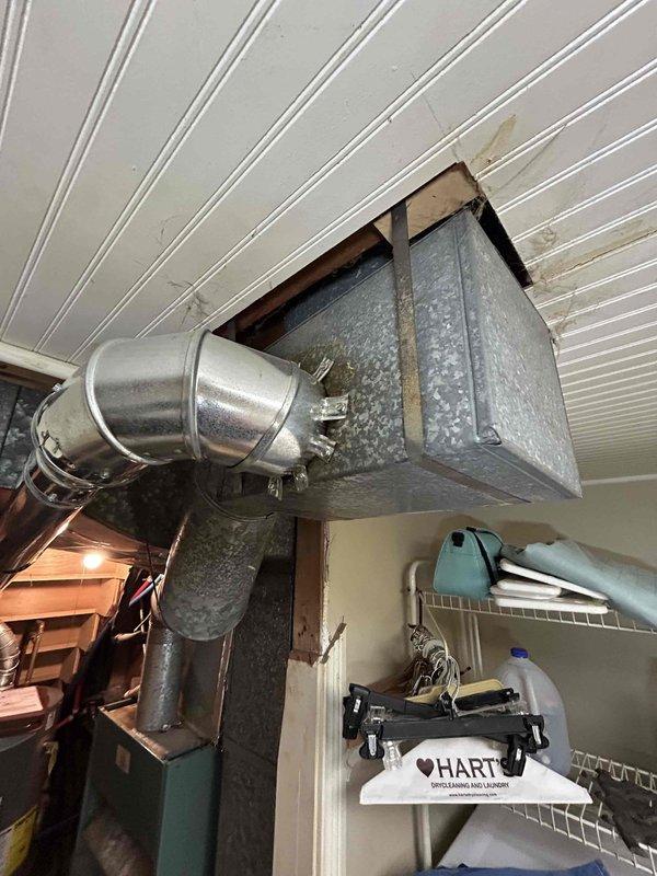 Conducted comprehensive inspection of 30+ year old HVAC system requiring urgent replacement. Current setup includes aging gas furnace located in basement under stairs, accessed through garage, with galvanized metal ductwork system featuring rectangular plenum box connected to round ducts. Customer requires immediate installation and is prepared for cash payment, though financing options may be considered.