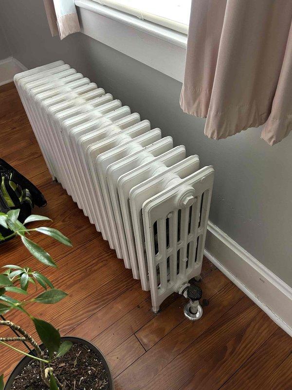 Responded to service call for no heat complaint. Inspected vintage cast iron radiator system and found stripped bleed valve requiring replacement on one unit. Examined boilers which showed significant oxidation and debris accumulation on heat exchanger coils. Replaced defective bleed valve and performed thorough cleaning of heat exchanger components to restore proper system functionality.