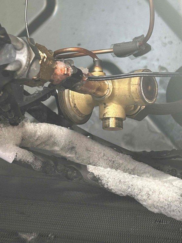 Responded to warranty service call for recently installed heat pump not heating properly. Inspection revealed insufficient refrigerant charge from initial installation as suspected. Observed corrosion at brass valve fitting assembly and inspected exterior line set insulation with visible damage. Added proper refrigerant charge and system now operating within manufacturer specifications.