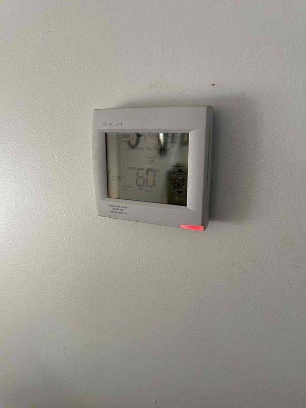 Conducted replacement estimate for Carrier heat pump system with upstairs air handler. Existing system inspection revealed functional Honeywell digital thermostat (currently reading 66°F) and utility closet-installed Carrier furnace unit with standard copper linesets and PVC connections. Customer seeking options but has not determined replacement timeline and does not require financing.
