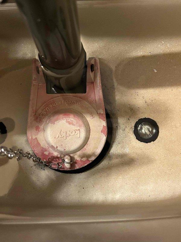 Conducted routine plumbing inspection per service agreement. Examined bathroom fixtures including wall-mounted supply lines with shut-off valve and faucet installation. Noted significant wear on faucet mounting flange with visible deterioration and color fading that may require future attention.