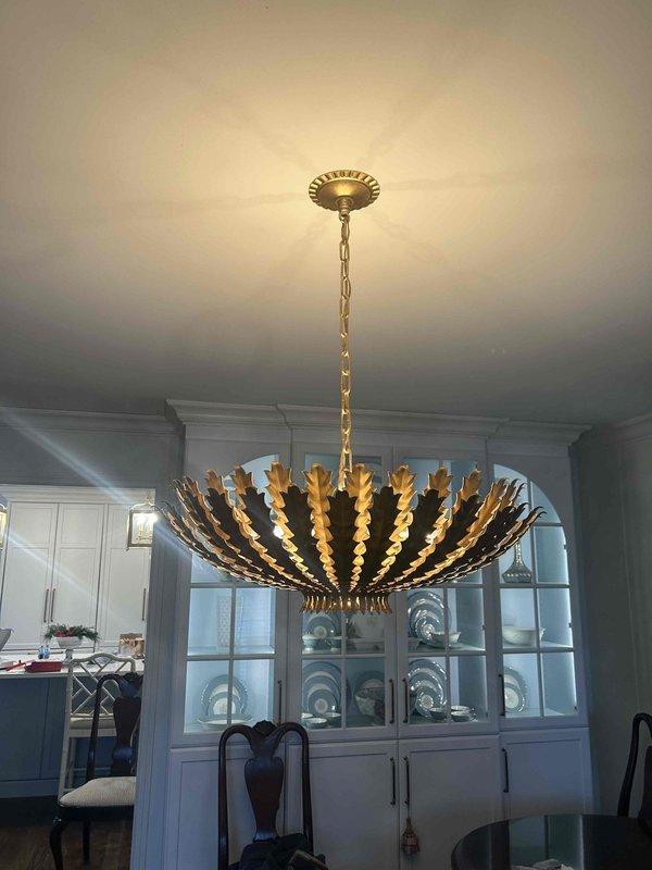 Removed and replaced three chandeliers in client's residence, including an ornate gold bloom-style fixture in the dining area and a black lantern-style pendant with three bulbs in the entryway. Successfully completed installation of all client-provided replacement fixtures with proper mounting and connection to existing electrical systems.