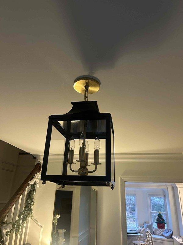 Removed and replaced three chandeliers in client's residence, including an ornate gold bloom-style fixture in the dining area and a black lantern-style pendant with three bulbs in the entryway. Successfully completed installation of all client-provided replacement fixtures with proper mounting and connection to existing electrical systems.