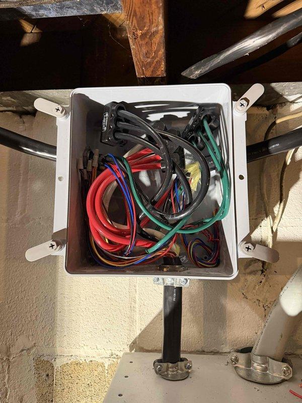 Completed installation of a 26KW generator system with dual 200AMP non-service entrance transfer switches. Work included installation of an energy manager for the upstairs geothermal system, a 100AMP load shed for downstairs geothermal unit, and a 50AMP load shed for water heater. All electrical connections properly terminated and secured with appropriate wire management throughout the system.