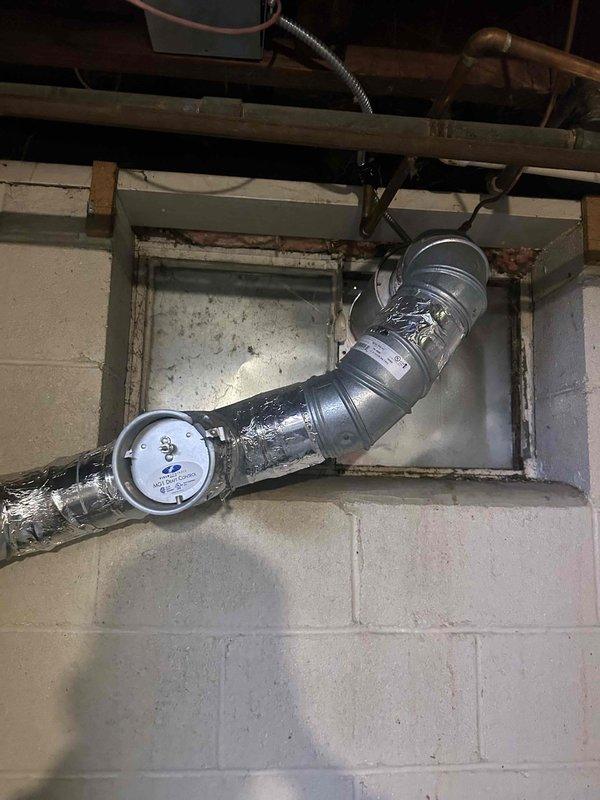 Conducted assessment of customer's dryer ductwork and diverter box installation previously completed by another contractor. Inspection revealed galvanized metal ductwork with reflective insulation tape, including a damper mechanism in the basement area. Evaluated flexible metal ducting running vertically and its connection points to determine requirements for relocation as requested.
