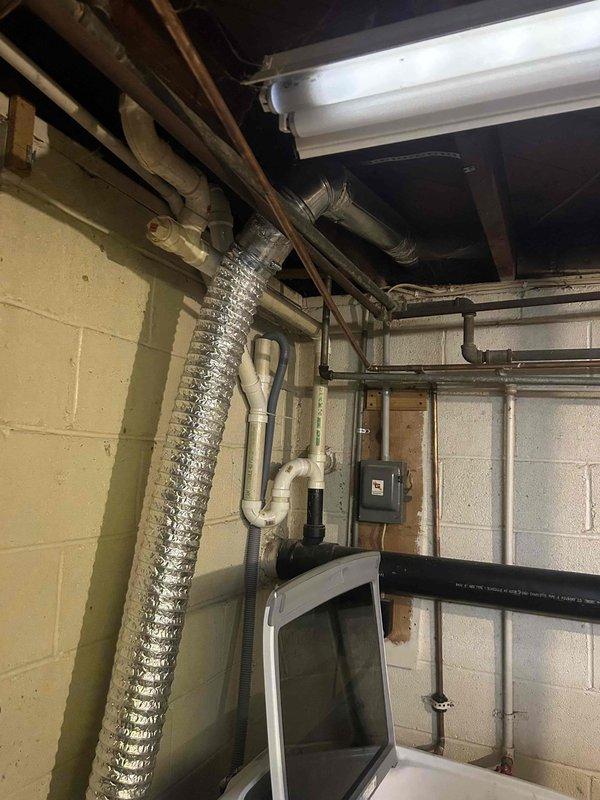 Conducted assessment of customer's dryer ductwork and diverter box installation previously completed by another contractor. Inspection revealed galvanized metal ductwork with reflective insulation tape, including a damper mechanism in the basement area. Evaluated flexible metal ducting running vertically and its connection points to determine requirements for relocation as requested.