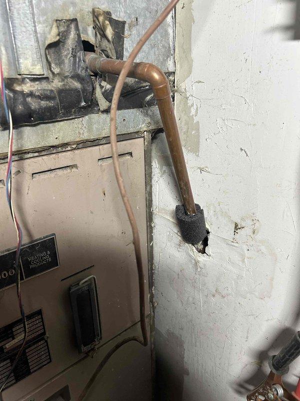 Conducted comprehensive estimate for replacement of two aging HVAC systems (27 and 40 years old) located in basement and crawlspace. Inspection revealed significant deterioration of existing equipment, including damaged metal housing, aging copper lines with inadequate insulation, and compromised ductwork. Documented structural concerns including water damage to surrounding walls and extensive degradation of wooden paneling that will need to be addressed during replacement.