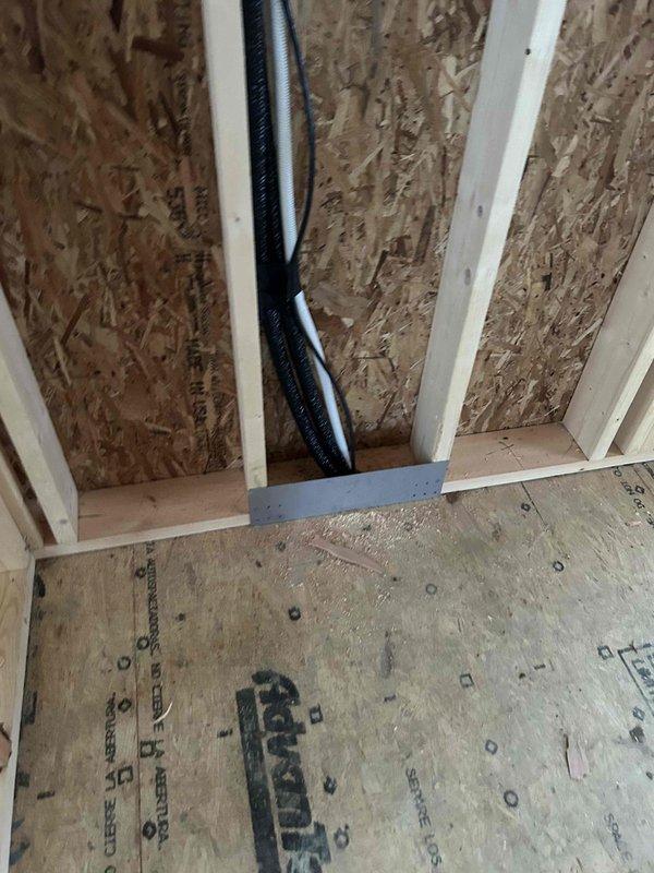 Completed installation of a Mitsubishi three-zone mini split system, featuring a 30K BTU hyper heat ductless heat pump outdoor unit with three indoor wall-mounted units (one 18K BTU and two 6K BTU blowers). All lineset piping, wiring, and drain lines were concealed in walls, with bathroom and dryer exhaust ductwork integrated into the system.