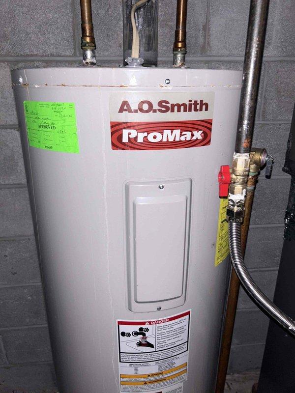 Conducted assessment on leaking A.O. Smith ProMax water heater located in basement. Unit is of undetermined age with breaker and supply valve currently turned off due to active leak. Customer seeking replacement options only. Visual inspection confirmed water heater installation against concrete block wall with copper supply lines, pressure relief valve, and treatment system present.