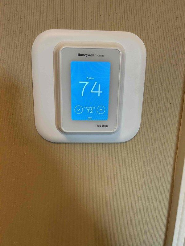 Responded to callback for newly installed AC system not adequately cooling upstairs. Inspected Honeywell Home Pro Series thermostat (set to 74° cooling to 72°) and outdoor condenser unit. Confirmed system operation, adjusted thermostat programming and balanced airflow distribution to improve cooling to second floor. System now functioning as designed.