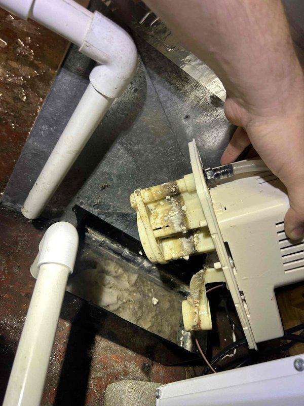 Inspected HVAC system for reported water leak and identified humidifier as source of problem. Discovered significant mineral buildup and corrosion on humidifier components, particularly the solenoid valve which showed extensive yellowing and scale accumulation. Replaced damaged valve, cleaned affected areas, and verified proper operation of the condensate drainage system to resolve the steady drip issue.
