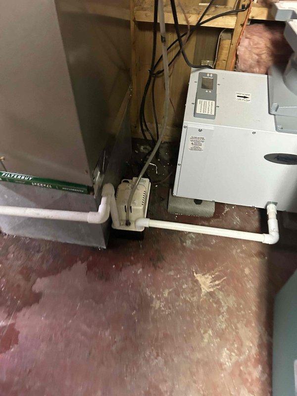 Inspected HVAC system for reported water leak and identified humidifier as source of problem. Discovered significant mineral buildup and corrosion on humidifier components, particularly the solenoid valve which showed extensive yellowing and scale accumulation. Replaced damaged valve, cleaned affected areas, and verified proper operation of the condensate drainage system to resolve the steady drip issue.