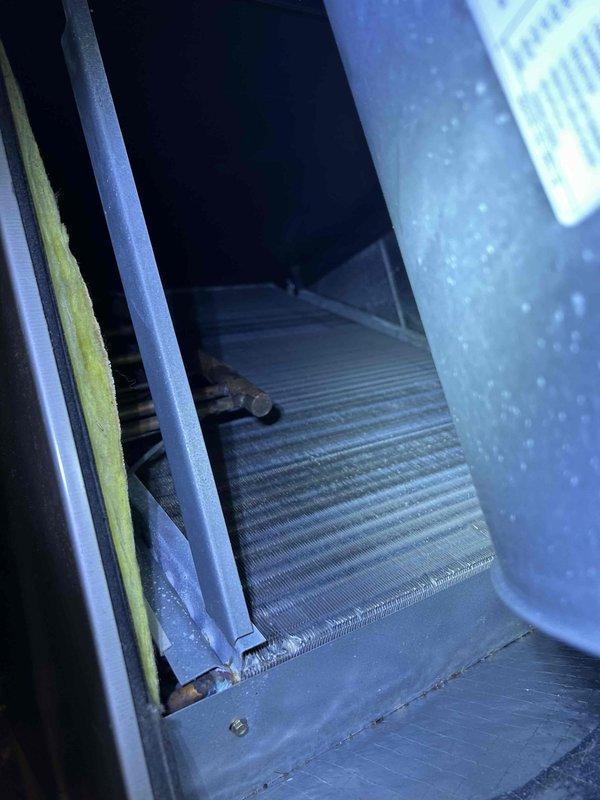 Completed seasonal tune-up on 10-year-old heat pump and air handler system located in basement. Inspected and photographed cooling coil/heat exchanger, noting some dust accumulation on the fins. Unit is due for 20x20x4 filter replacement during upcoming Fall and Spring maintenance visits.