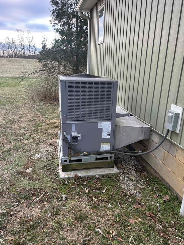 Performed annual maintenance on residential heat pump/propane package unit mounted on side of house. Inspected and tested system operation with unit running at 84°F ambient temperature while thermostat was set to 68°F heat mode. All components functioning correctly with no issues identified.