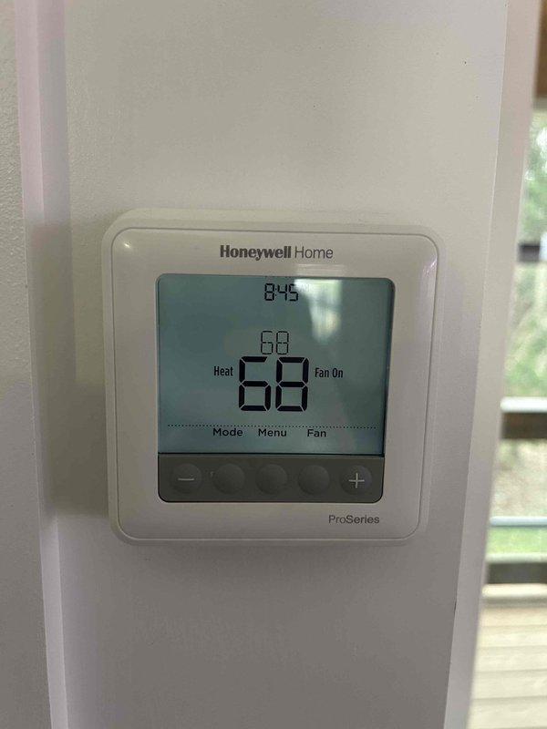 Performed annual maintenance on residential heat pump/propane package unit mounted on side of house. Inspected and tested system operation with unit running at 84°F ambient temperature while thermostat was set to 68°F heat mode. All components functioning correctly with no issues identified.