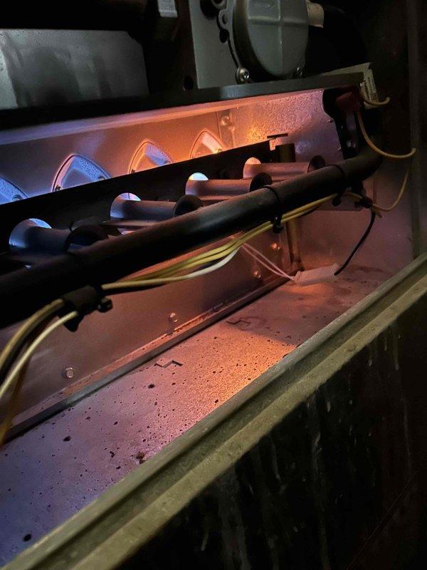 Responded to no heat call for 10-year-old gas furnace blowing cool air. Diagnostic testing revealed condensation on heat exchanger and humidity readings of 13.4%. Determined failed secondary heat exchanger was causing system issues; recommended replacement due to age and repair cost factors.
