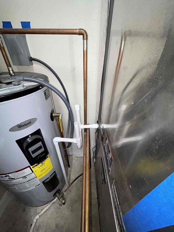 Performed comprehensive maintenance on a 15-year-old Whirlpool water heater (Model ES50R9-55 100, S/N 1619102970189) experiencing musty/moldy water odors despite previous draining. Observed significant calcium buildup and corrosion on the brass drain valve (038IN), which connects to the geothermal system. Replaced deteriorated drain valve, installed new anode rod, and conducted thorough system flush to address water quality issues. Verified proper operation after service completion.