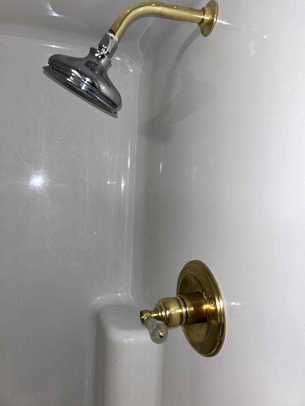 Responded to service call for shower in master bath with dual issues: leaking/dripping and lack of hot water. Diagnosed faulty valve cartridge as the root cause of both problems. Replaced defective valve cartridge with new component, restoring proper temperature control and eliminating the leak.