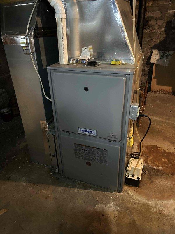 Responded to no heat complaint for 10-year-old Tempstar gas furnace. Inspection revealed corrosion on blower motor housing and significant rust on valve assembly. Replaced failed blower motor and cleaned corroded electrical connections to restore proper system operation. System now functioning correctly with normal heat output.