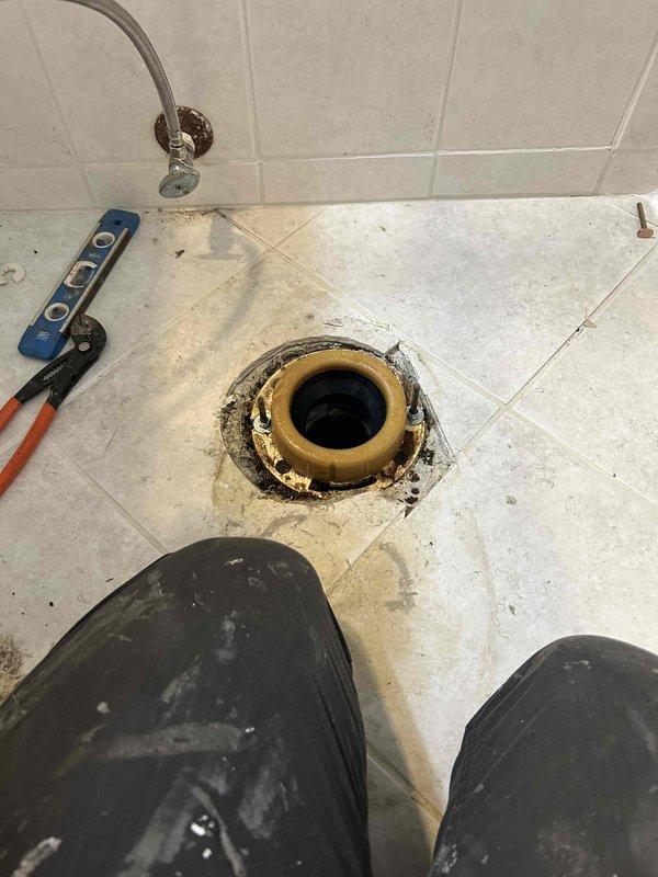 Completed toilet pull and reset service, replacing severely corroded toilet flange. Installed new wax ring, supply line, and toilet bolts to resolve drainage issues and prevent future leakage.
