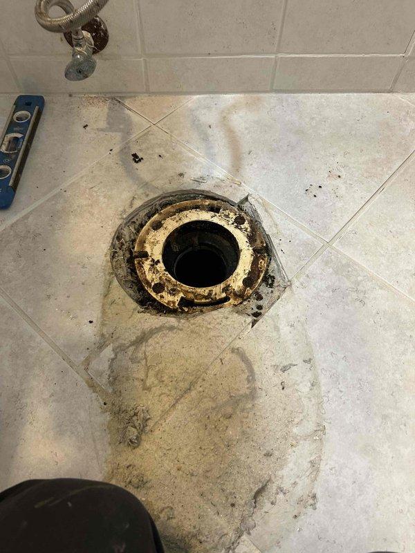 Completed toilet pull and reset service, replacing severely corroded toilet flange. Installed new wax ring, supply line, and toilet bolts to resolve drainage issues and prevent future leakage.