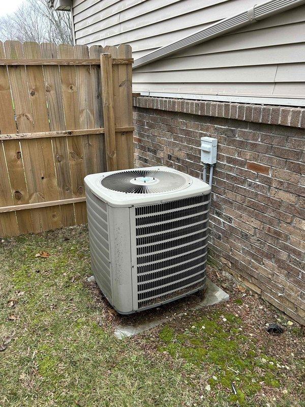 Performed tune-up service on 10+ year old heat pump system with air handler located in crawlspace. Conducted electrical diagnostic testing on the outdoor condenser unit, measuring voltage (196.0V) with digital multimeter to verify proper electrical supply. Unable to inspect air filter as customer and son could not locate it; recommended standard replacement filters and documented filter size information for future reference.