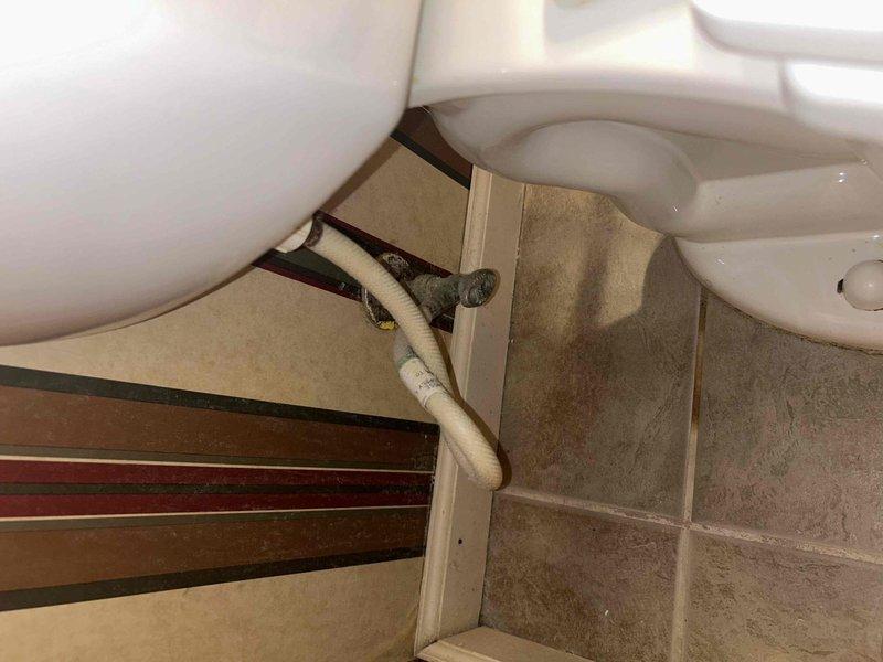 Conducted routine plumbing inspection as part of a PSA service appointment. Examined toilet/sink plumbing connections, noting minor corrosion on water supply line that may require future attention. Inspected water heater system with focus on copper pipe connections and drainage components, confirming proper installation and functional operation of all elements.