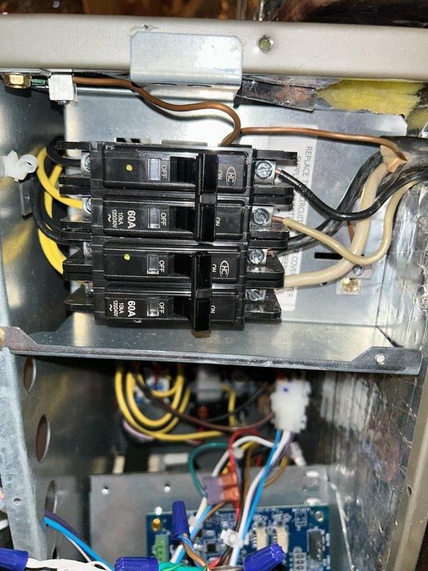 Responded to callback regarding blank thermostat and system non-operation. Inspected electrical connections at circuit breaker panel and control board, noting proper wire terminations on the 60A breakers and control circuit. Verified system operation after correcting loose connection at thermostat backplate. System functioning normally at time of departure.