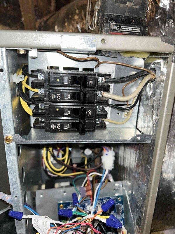 Responded to callback regarding blank thermostat and system non-operation. Inspected electrical connections at circuit breaker panel and control board, noting proper wire terminations on the 60A breakers and control circuit. Verified system operation after correcting loose connection at thermostat backplate. System functioning normally at time of departure.