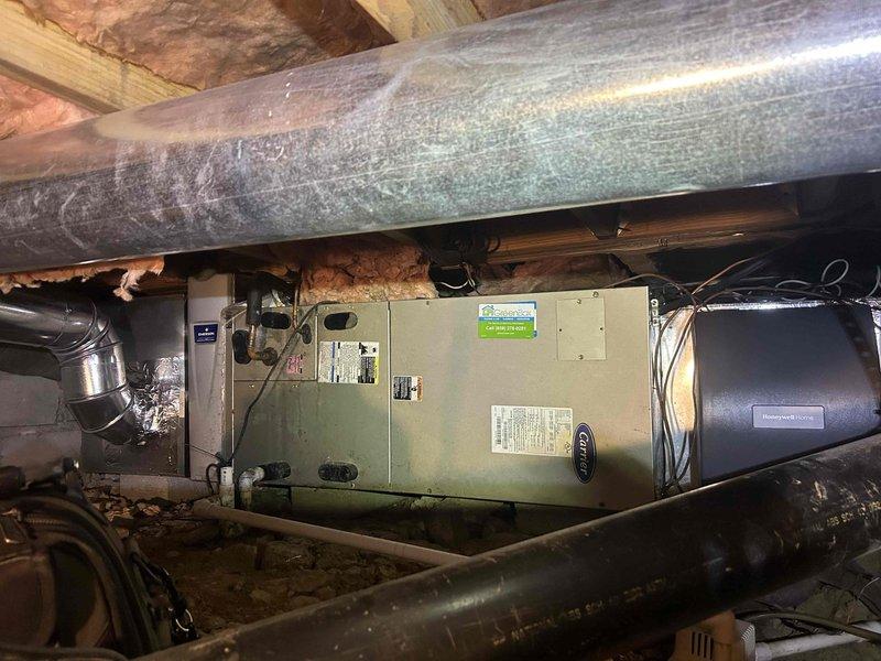 Responded to no heat complaint for 15-year-old heat pump system located in restricted crawl space access. Upon inspection, found significant accumulation of dust and debris in ductwork and around air handler unit. Performed comprehensive system cleaning, cleared blocked return air pathway, and replaced worn insulation on main supply duct that showed signs of deterioration. System now operating at proper capacity and providing adequate heat to residence.