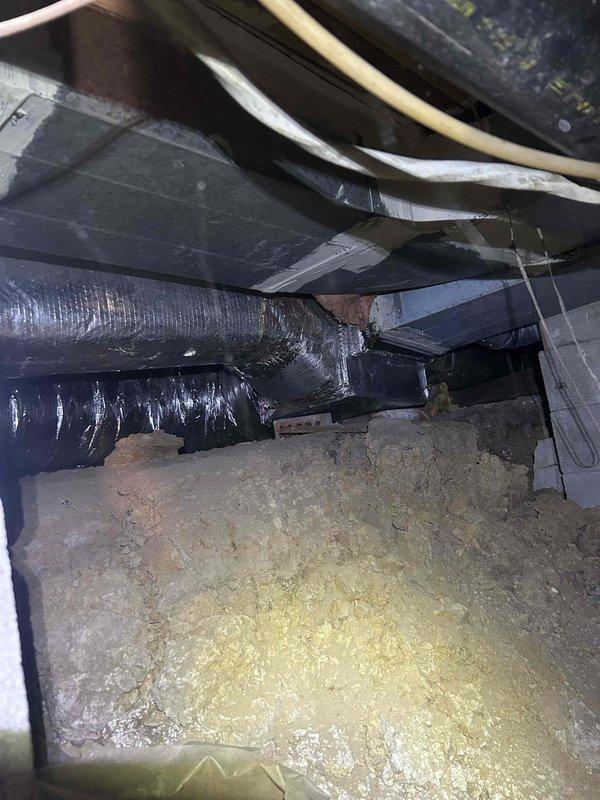 Responded to no heat complaint for 15-year-old heat pump system located in restricted crawl space access. Upon inspection, found significant accumulation of dust and debris in ductwork and around air handler unit. Performed comprehensive system cleaning, cleared blocked return air pathway, and replaced worn insulation on main supply duct that showed signs of deterioration. System now operating at proper capacity and providing adequate heat to residence.