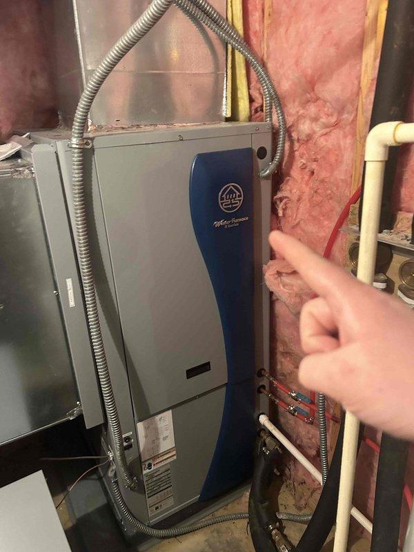 Completed geothermal system tune-up service on two units located in basement and attic as part of customer's Care Plan agreement. Inspected Aire brand HVAC system in utility area with proper ductwork and connections. Verified thermostat operation (heat mode functioning correctly with temperature reading at 65°F) and confirmed system response to controls.