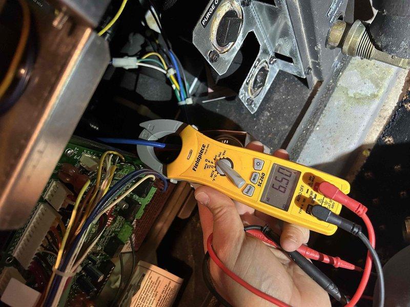 Performed comprehensive Care Plan Tune Up on GEO system in main house. Conducted electrical diagnostics using multimeter to verify proper voltage readings at control board, measuring 6.57V within acceptable parameters. Inspected and cleaned blower assembly components to ensure optimal airflow and system efficiency.