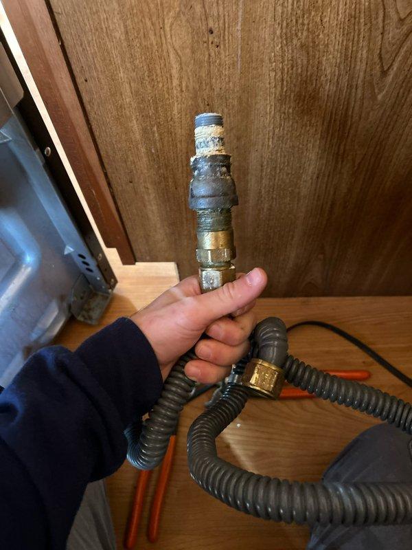 Responded to reported gas leak concern following removal and reinstallation of stove by handyman. Conducted comprehensive inspection of gas supply system, focusing on connection points and fittings. Located damaged gas connection fitting with improper sealing tape application at stove connection point. Replaced deteriorated fitting and properly sealed connection, then performed pressure test to verify system integrity. All gas connections now secure with no detectable leaks.