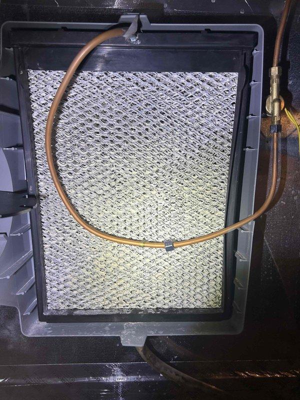 Responded to E3 error code on basement HVAC system by replacing humidifier filter #35 as requested. Inspected upstairs unit where temperature was not maintaining setpoint (reading 81°F), indicating possible thermostat malfunction. Documented condition of evaporator coil and filtration components through photos for follow-up service.