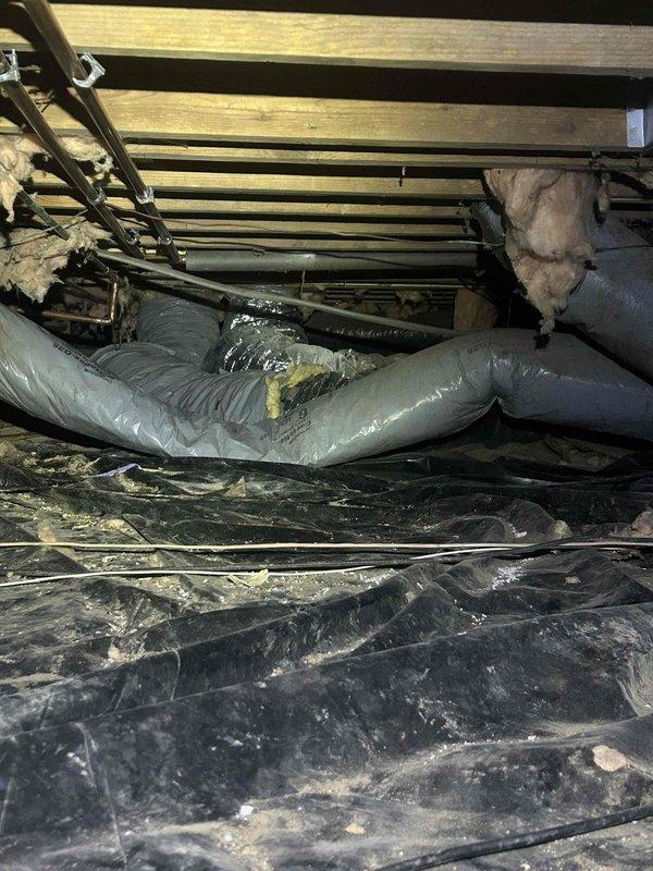 Responded to customer request regarding system performance issues. Upon inspection, discovered significant ice formation on the evaporator coil indicating restricted airflow and possible refrigerant problems. Additionally noted sagging flexible ductwork in the crawlspace requiring proper support. Performed coil defrosting and cleaning, secured loose ductwork with appropriate strapping, and restored system to proper working order.