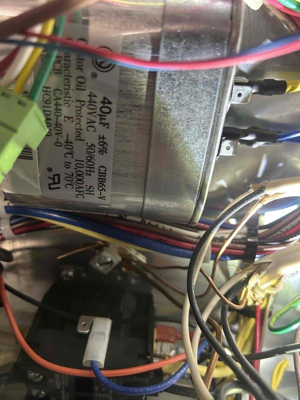 Performed scheduled maintenance on 3-year-old geothermal system. Inspected capacitor connections and verified proper rating (40μF 5% at 370VAC). Examined cooling coil condition; noted normal condensation present with no significant dust accumulation or fin damage. Customer self-maintains steam humidifier; EAC was also inspected during service.