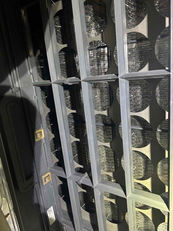 Performed tune-up service on two separate HVAC systems (one unit located in crawlspace, one in attic). Inspected capacitor on one system (Genteq 5MFD 208/230VAC) which appeared functional despite minor dust accumulation. Examined air filtration system which showed moderate dust buildup; recommended replacement of filters to maintain optimal system performance.