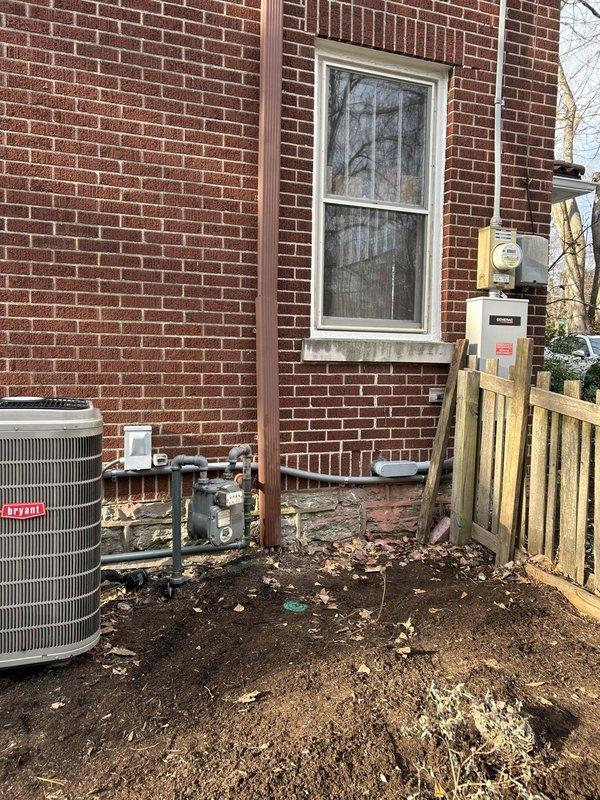 Successfully installed Generac 22KW standby generator with 200 AMP automatic transfer switch alongside 50AMP load shed for larger AC unit. Removed unused gate circuit to create space for surge protector and modified garage feed to 120V to accommodate new equipment installation. Generator placement completed adjacent to existing Bryant HVAC system with proper utility connections.