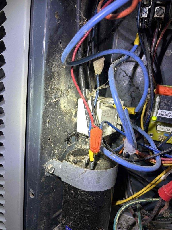Responded to customer concern of abnormally high electricity consumption from heat pump system. Inspected Braeburn programmable thermostat which was functioning normally (set to 71°, reading 73° with heat mode active). Examined interior wiring connections and found significant dust accumulation and aging wire insulation in the control board area. Cleaned connections and verified proper operation of the heat pump system, confirming it was functioning as designed with no electrical issues detected.