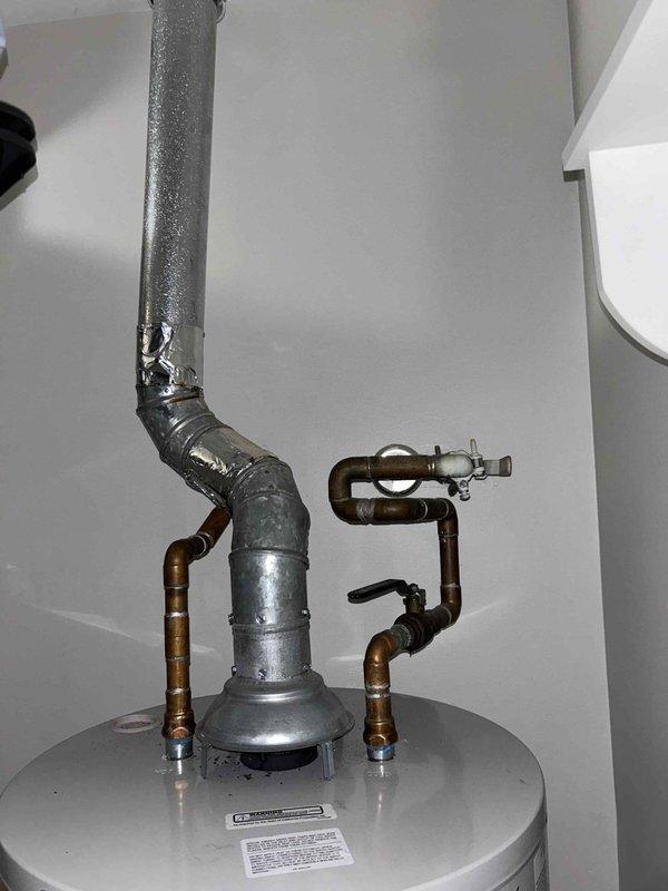Conducted routine plumbing inspection as part of preventive service agreement. Examined water heater system, checking all connections, exhaust venting, and supply pipes for proper installation and potential leaks. Also inspected bathroom shower fixture, including handheld showerhead, sliding rail system, control valve, and flexible hose connection - all components found to be in good working condition with no visible issues.
