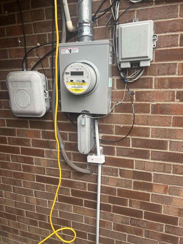 Inspected customer's electrical system to address reported issue with lights flickering throughout the house when turned off. Visual examination of the exterior service entrance, meter installation, and panel connection revealed no obvious defects. Service panel appears to be properly installed with standard Milbank meter and appropriate conduit connections.
