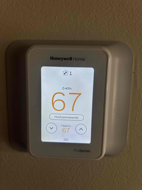 Performed scheduled maintenance on residential HVAC system with attic-mounted air handler. Inspected and confirmed proper operation of Honeywell ProSeries smart thermostat (displaying 67°F with 40% battery). System running efficiently with all ductwork properly sealed and insulated.