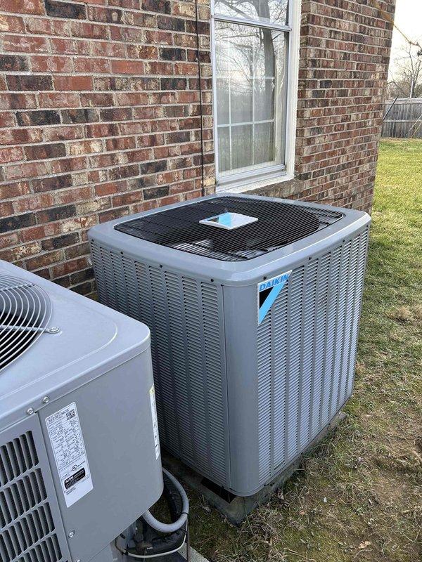 Successfully replaced customer's outdoor AC unit under warranty. Installed new Daikin equipment in the existing location between brick wall and building exterior, ensuring proper positioning and connection of all refrigerant lines and electrical components. Unit is now operational and warranty service is complete.